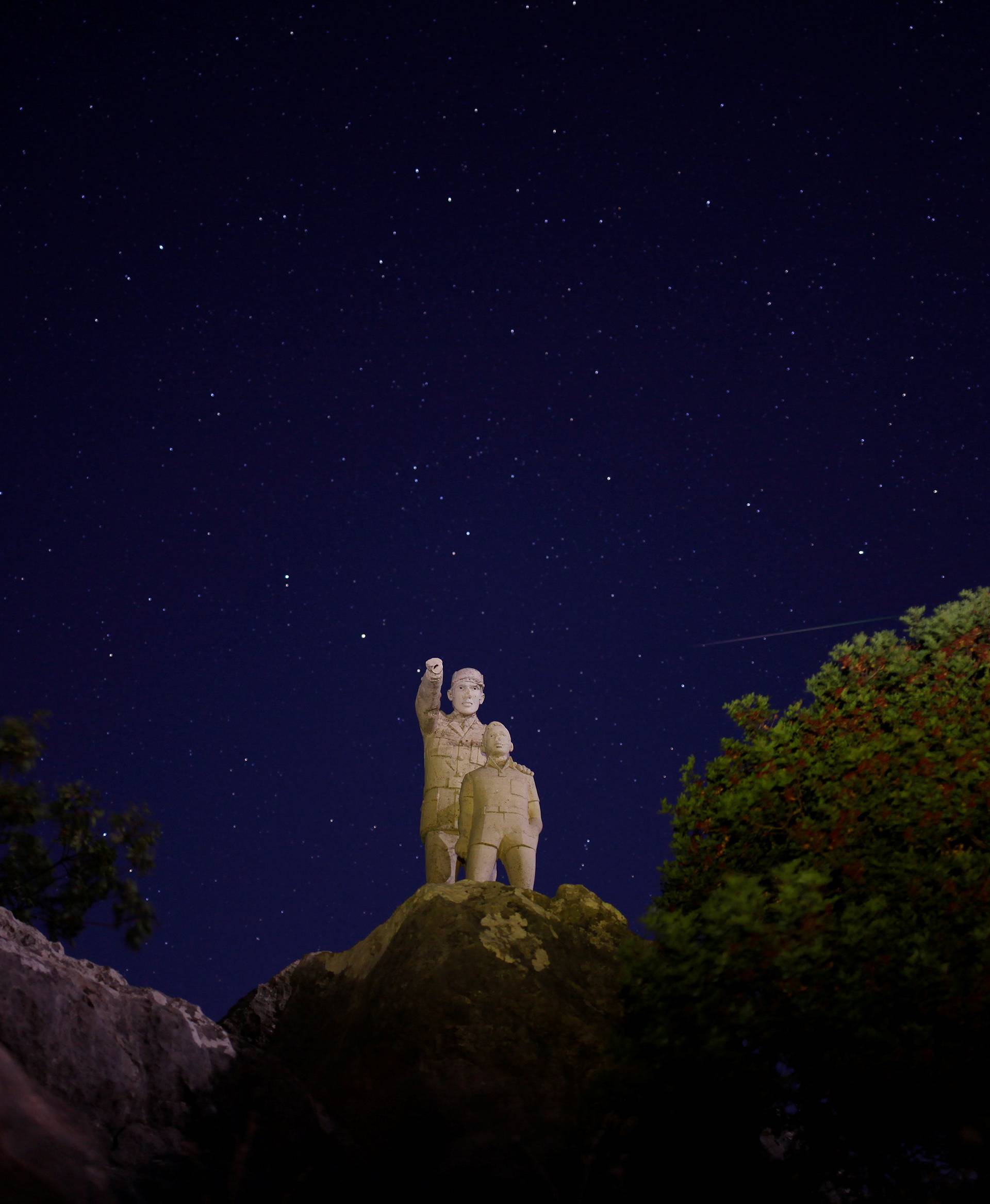 A meteor streaks past stars in the night sky during the annual Perseid meteor shower at a nature park and biosphere reserve near Malaga