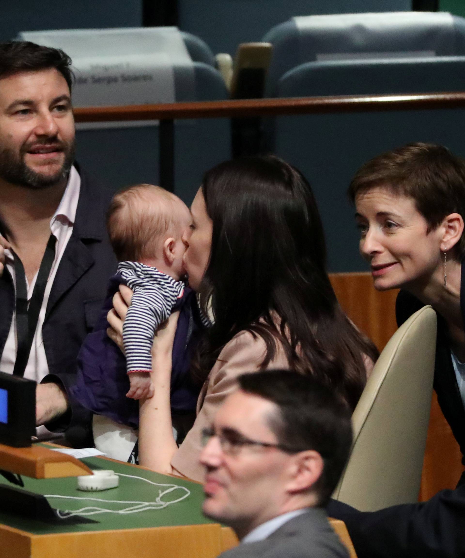 New Zealand Prime Minister Jacinda Ardern kisses her baby Neve before speaking at the Nelson Mandela Peace Summit during the 73rd United Nations General Assembly in New York
