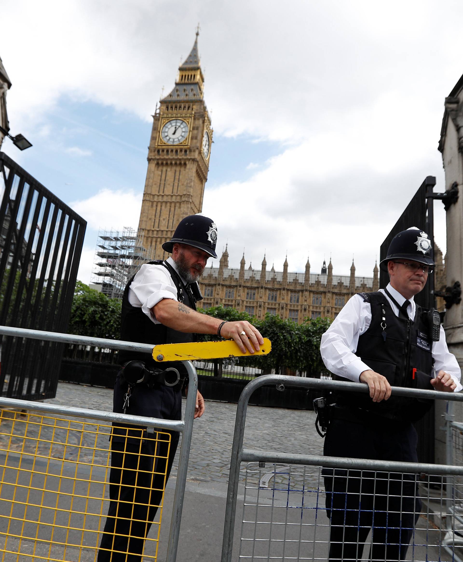 Armed police officers secure the Carriage Gate entrance as they stand outside the Palace of Westminster, in central London