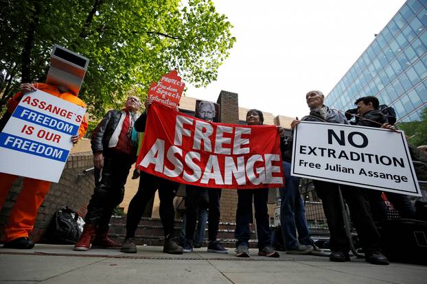 People hold signs during a protest outside Southwark Crown Court where WikiLeaks founder Julian Assange will be sentenced, in London