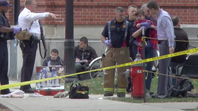 A girl is led to an ambulance by emergency personnel following an attack at Ohio State University's campus in Columbus