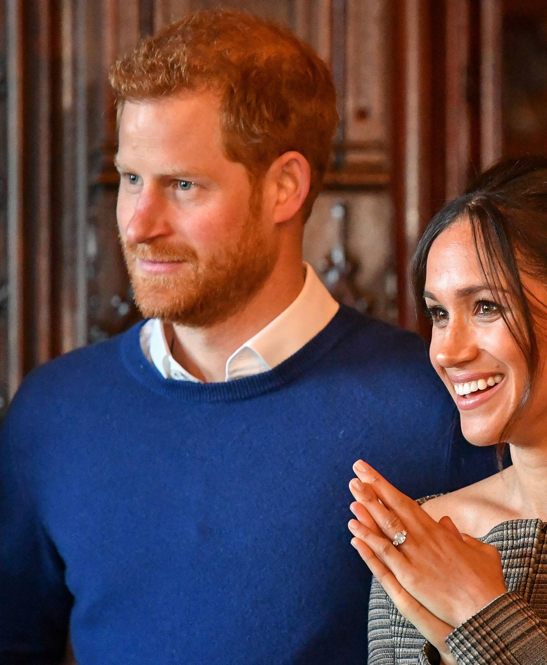 Britain's Prince Harry and his fiancee Meghan Markle watch a performance by a Welsh choir in the banqueting hall during a visit to Cardiff Castle in Cardiff