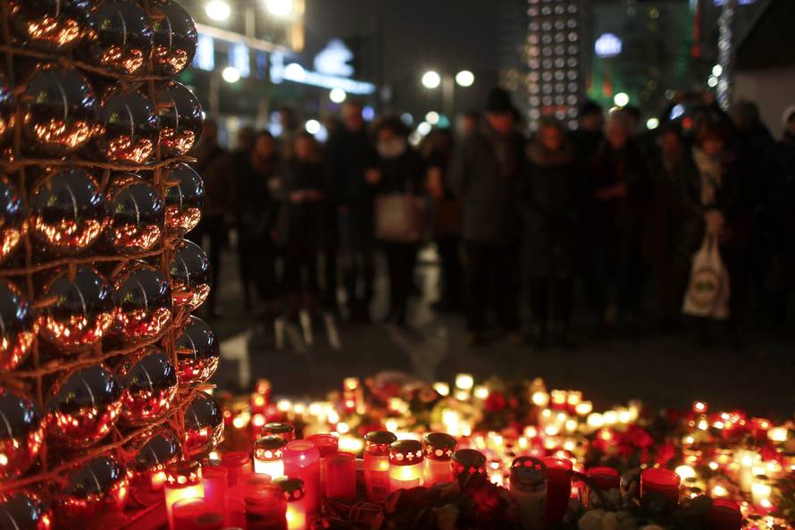 Candles burn at a Christmas market in Berlin,