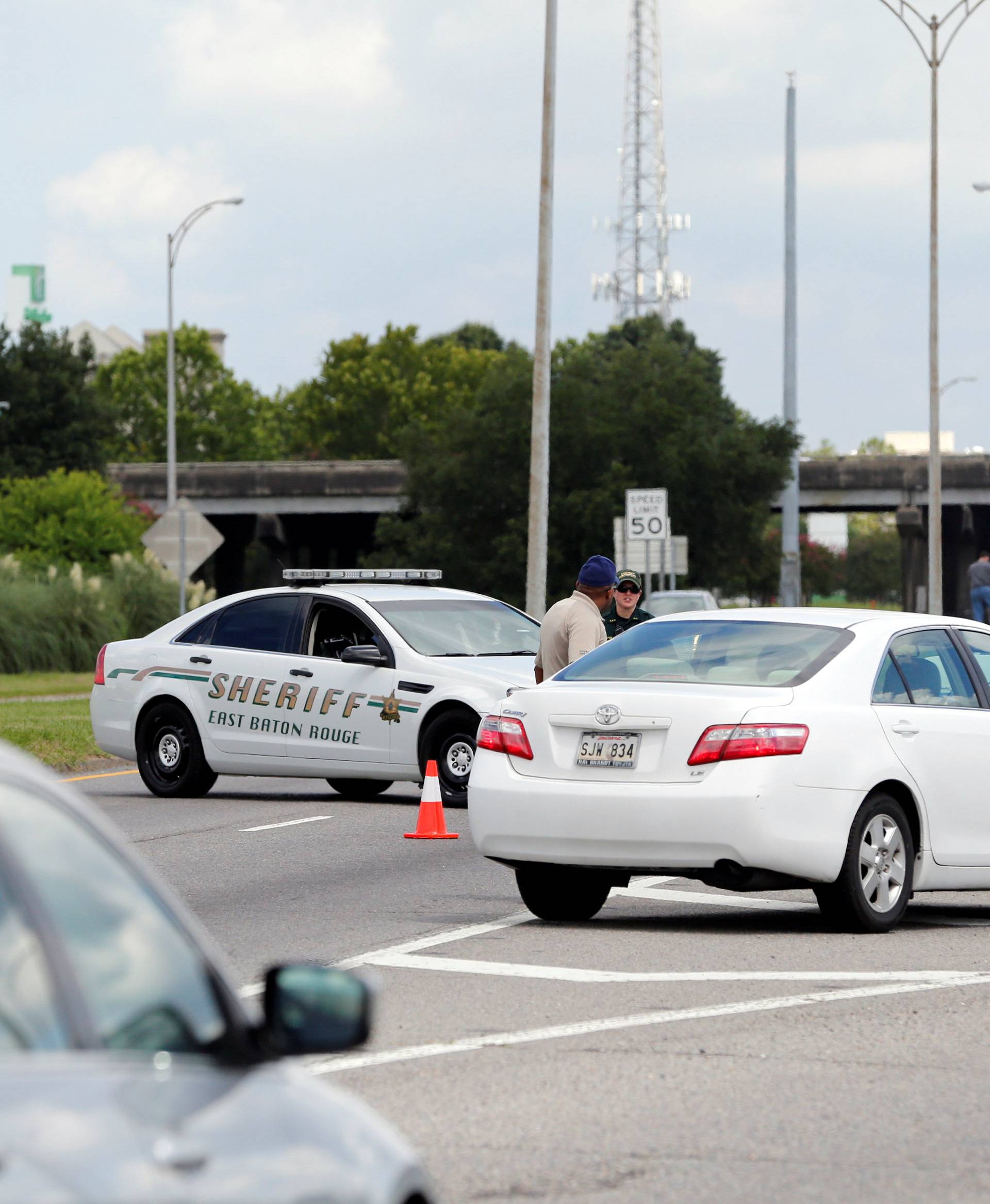 Police officers block off a road after a shooting of police in Baton Rouge