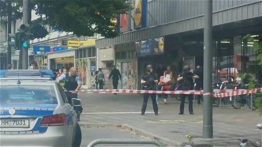 Security forces are seen after a knife attack in a supermarket in Hamburg
