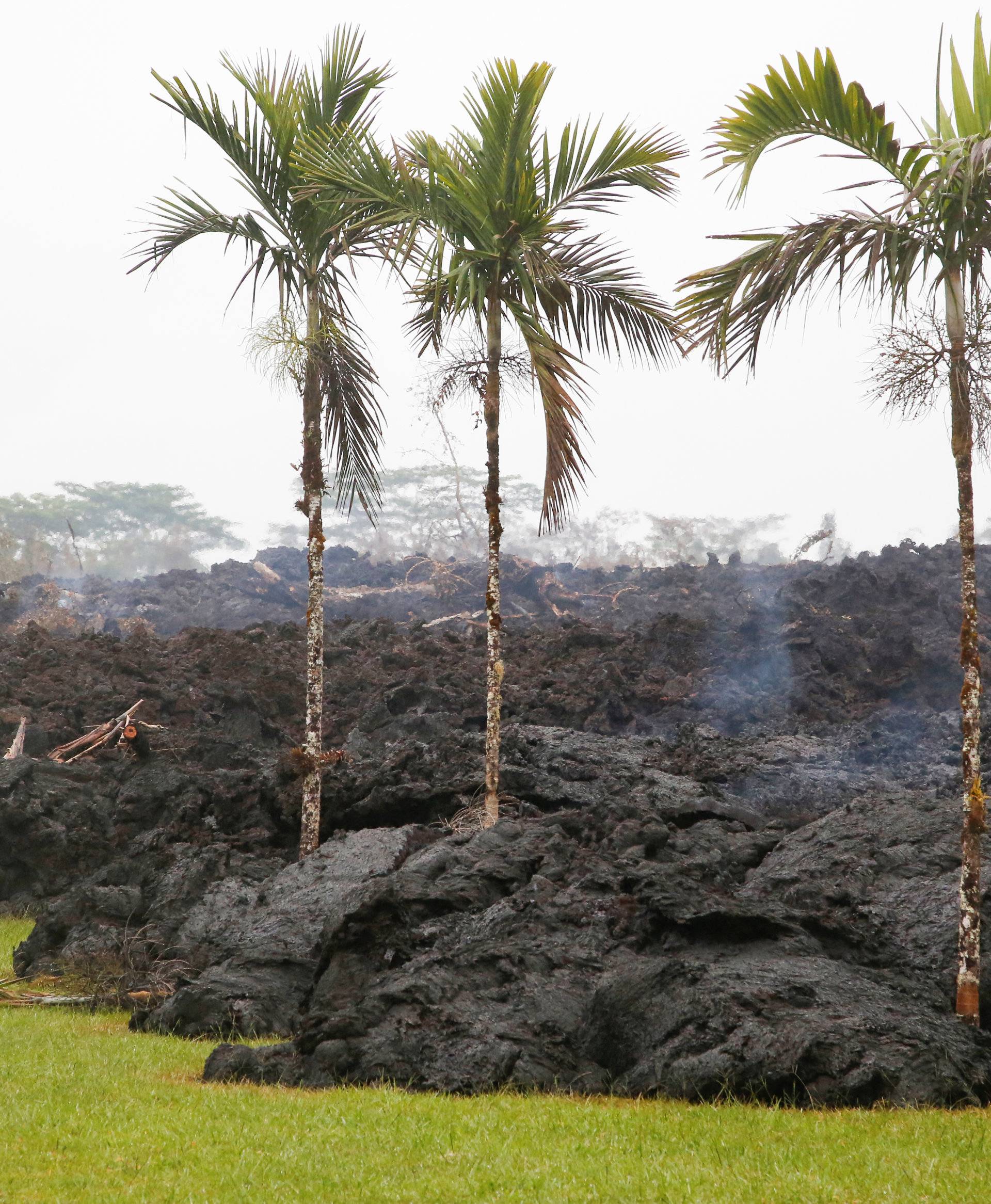 Lava cools in a resident's yard in the Leilani Estates subdivision during ongoing eruptions of the Kilauea Volcano
