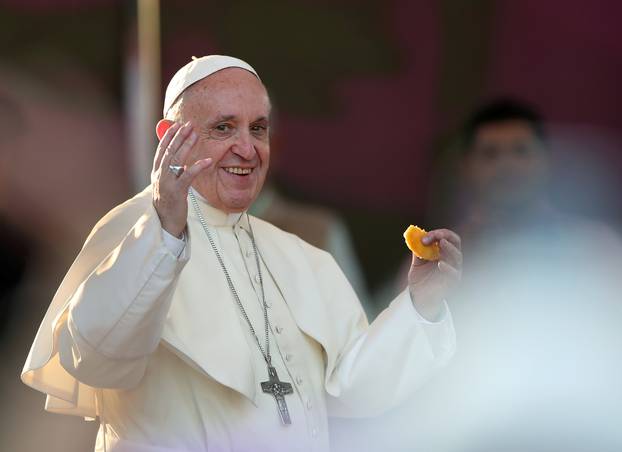 Pope Francis tries a sopaipilla, a typical Chilean pastry, at  the San Alberto Hurtado shrine, in Santiago