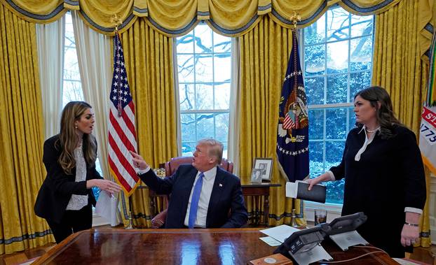 U.S. President Donald Trump speaks with Hope Hicks during an interview with Reuters in Washington