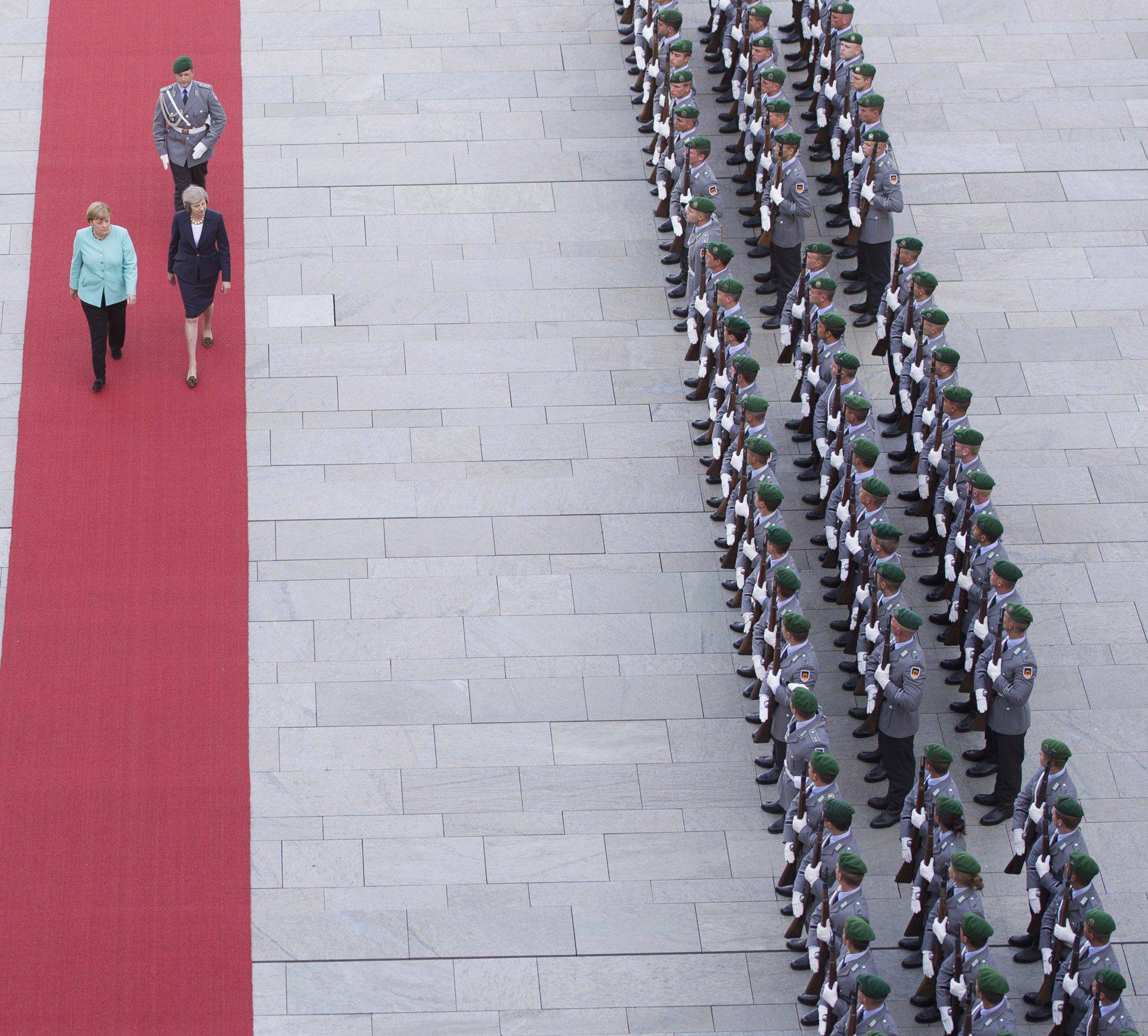 German Chancellor Merkel and Britain's Prime Minister May review honour guard in Berlin