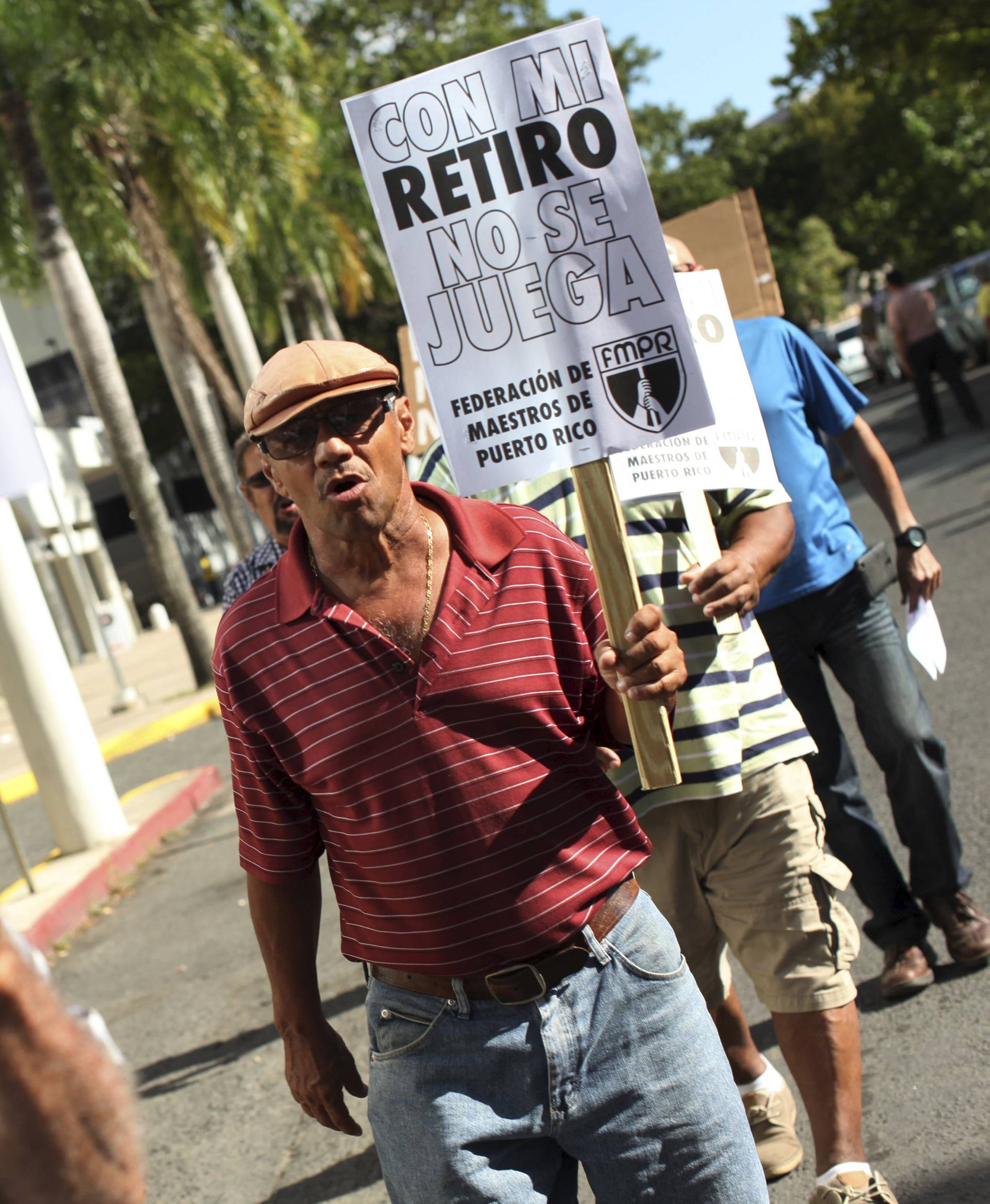 Members of the Committee of retired Teachers of Puerto Rico's Teachers Federation protest in San Juan