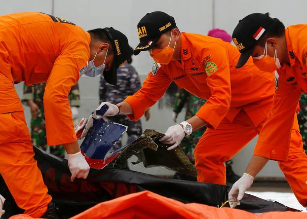 Indonesian rescue members inspect what is believed to be the remains of the Sriwijaya Air plane flight SJ182, which crashed into the sea, at Jakarta International Container Terminal port in Jakarta