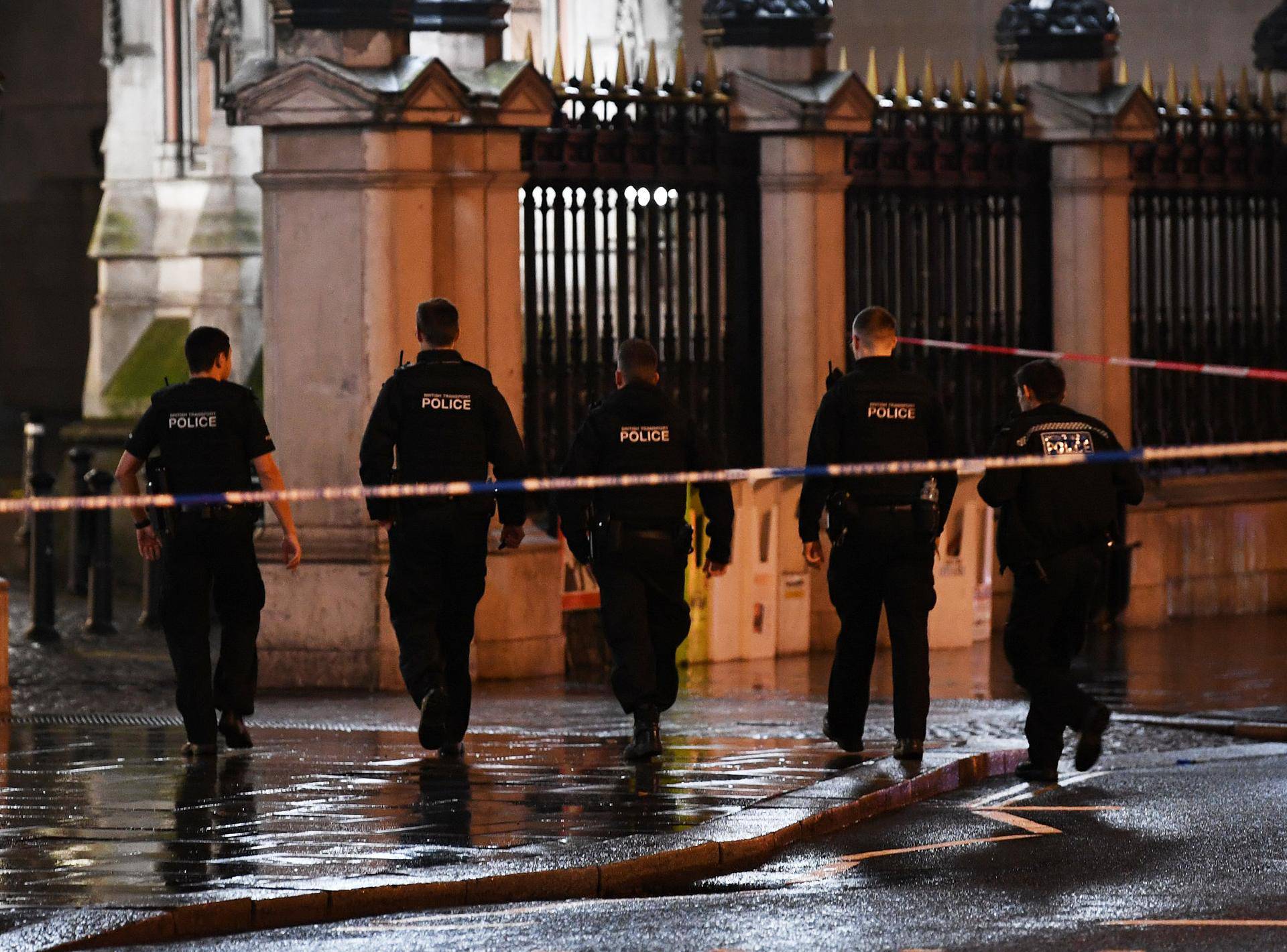 Police officers walk towards Charing Cross station after it was shut due to a gas leak, in London