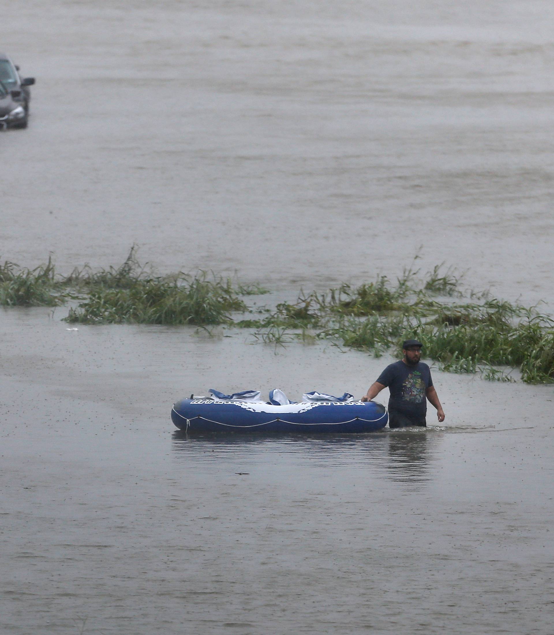 Resident wades through flood waters from Tropical Storm Harvey in east Houston