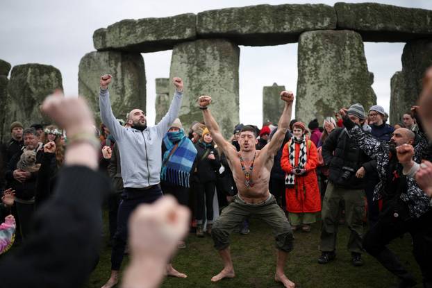 Winter solstice celebrations during sunrise at Stonehenge