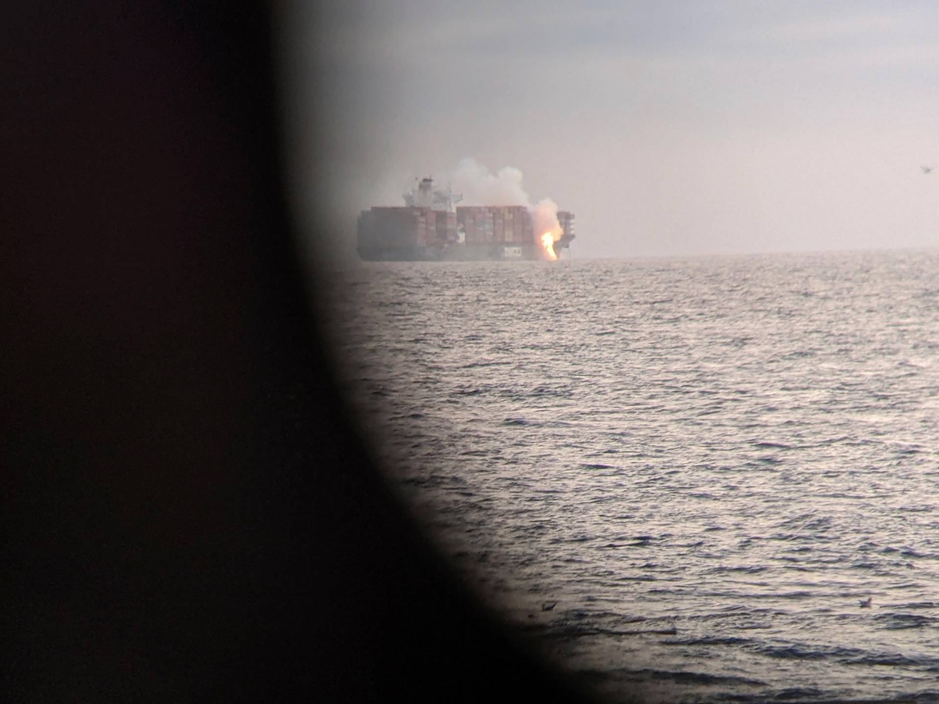 Fire cascades down from the deck of the container ship ZIM Kingston into the waters off the coast of Victoria, British Columbia, Canada