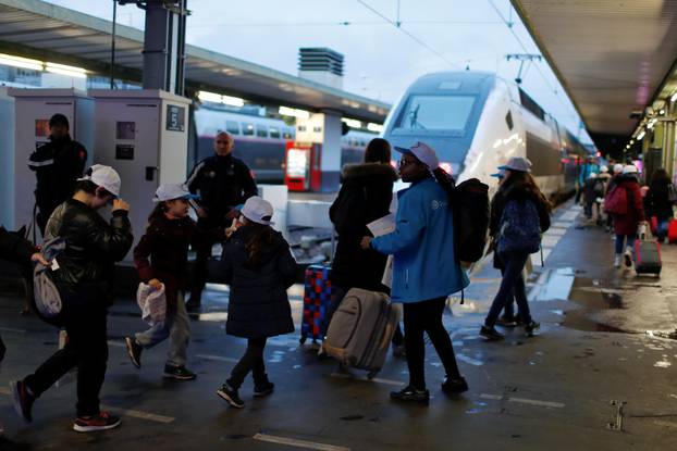 Minors traveling with service for unaccompanied children "Junior et compagnie" walk at Gare de Lyon train station in Paris