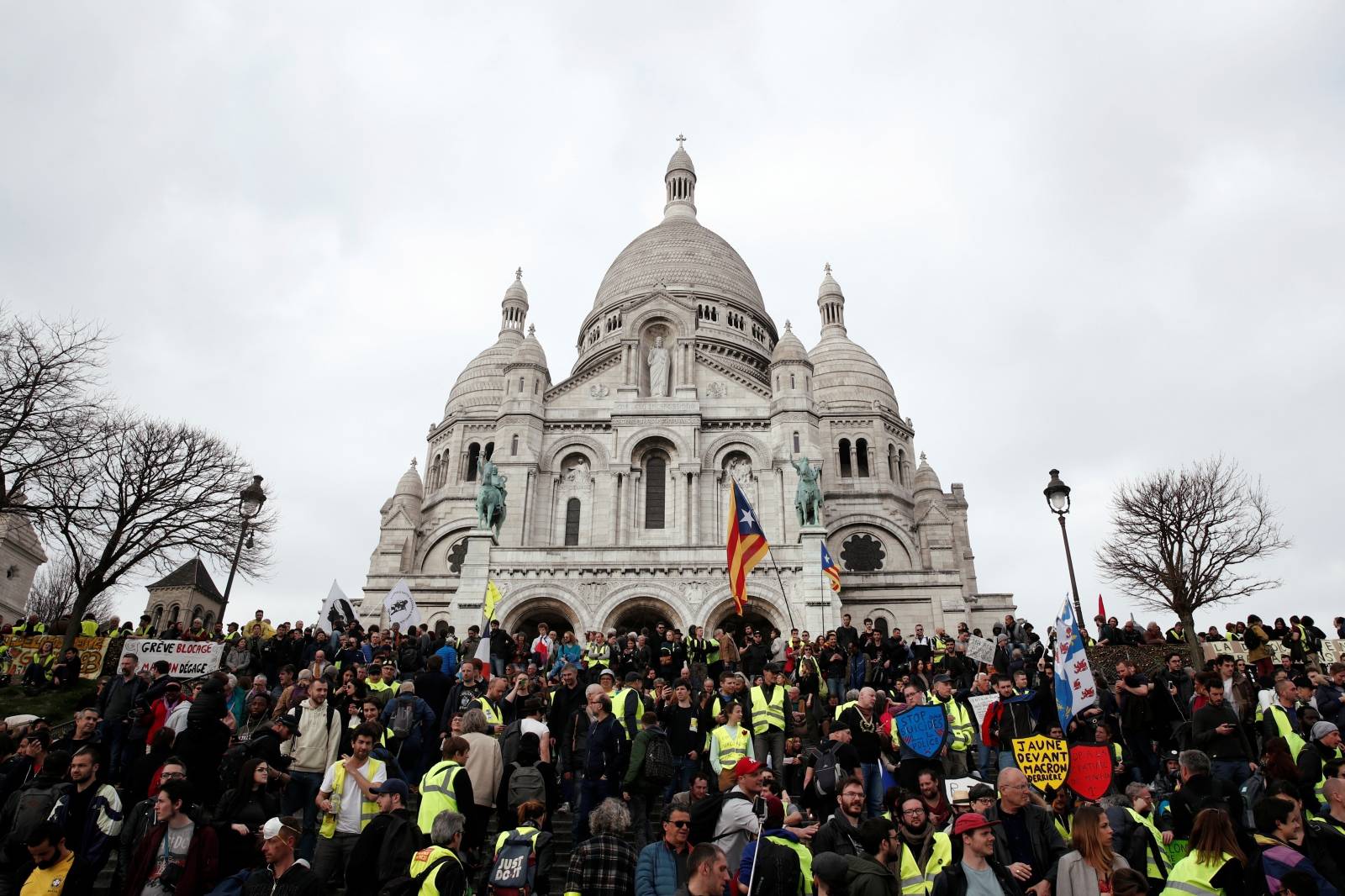 Protesters wearing yellow vests attend a demonstration in front of the Sacre-Coeur Basilica of Montmartre during the Act XIX (the 19th consecutive national protest on Saturday) of the "yellow vests" movement in Paris