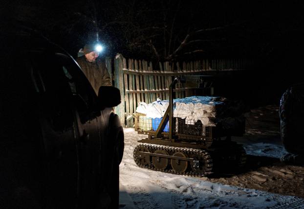 Ukrainian servicemen operate an unmanned ground vehicle fit for delivery missions on the frontline in Donetsk region