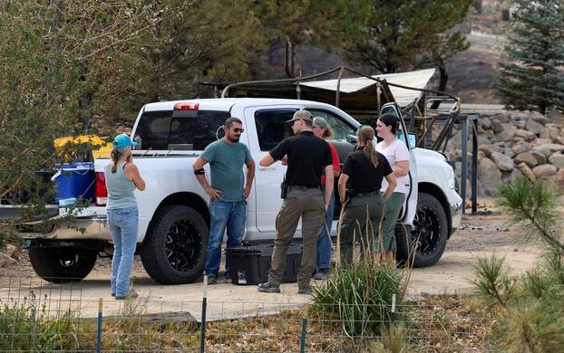 Residents and officials talk near burned homes at Hawk Fire in Reno