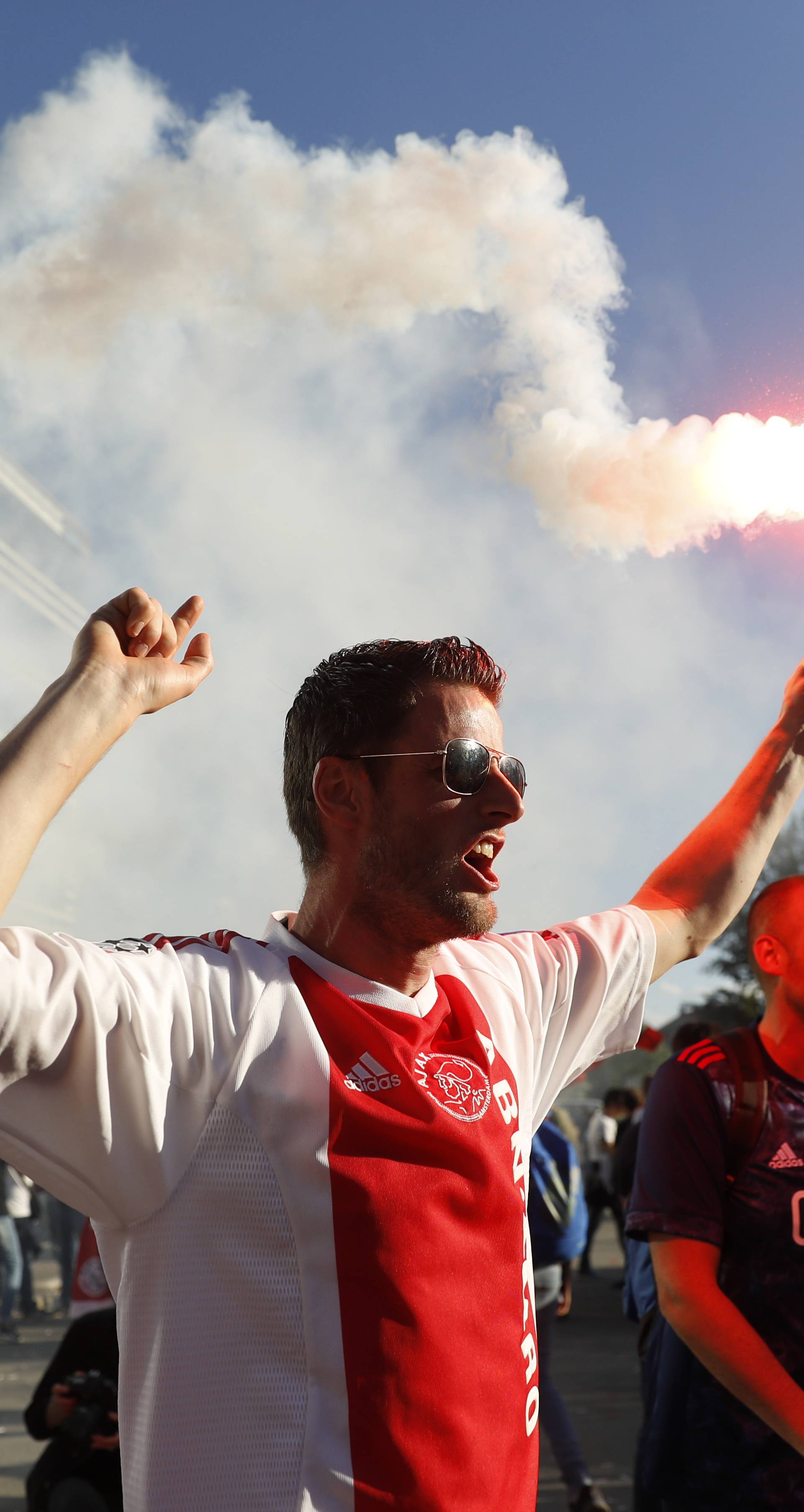 Ajax fan with a flare outside the stadium before the match