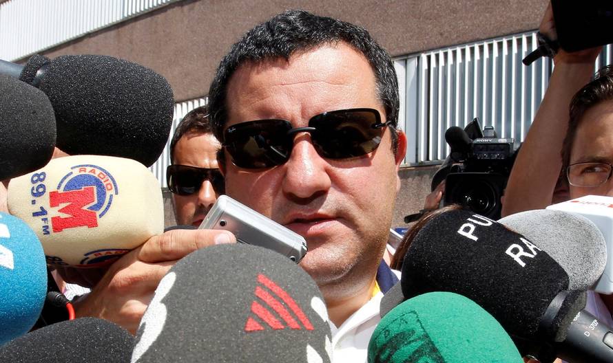 FILE PHOTO: Soccer agent Mino Raiola speaks to the media as he arrives at FC Barcelona's office in Barcelona