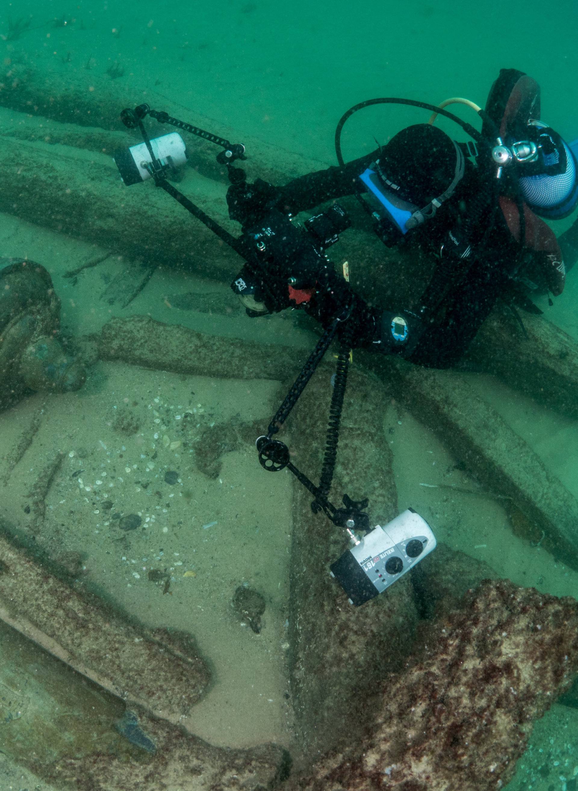 Divers are seen during the discovery of a centuries-old shipwreck, in Cascais