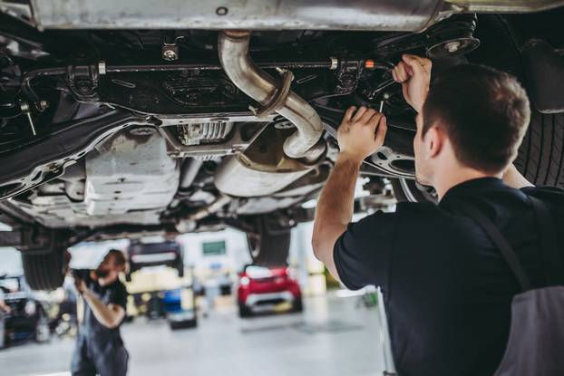 Two,Handsome,Mechanics,In,Uniform,Are,Working,In,Auto,Service