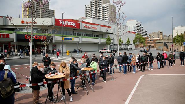 People wait to get vaccinated at mobile vaccination centre in Cologne