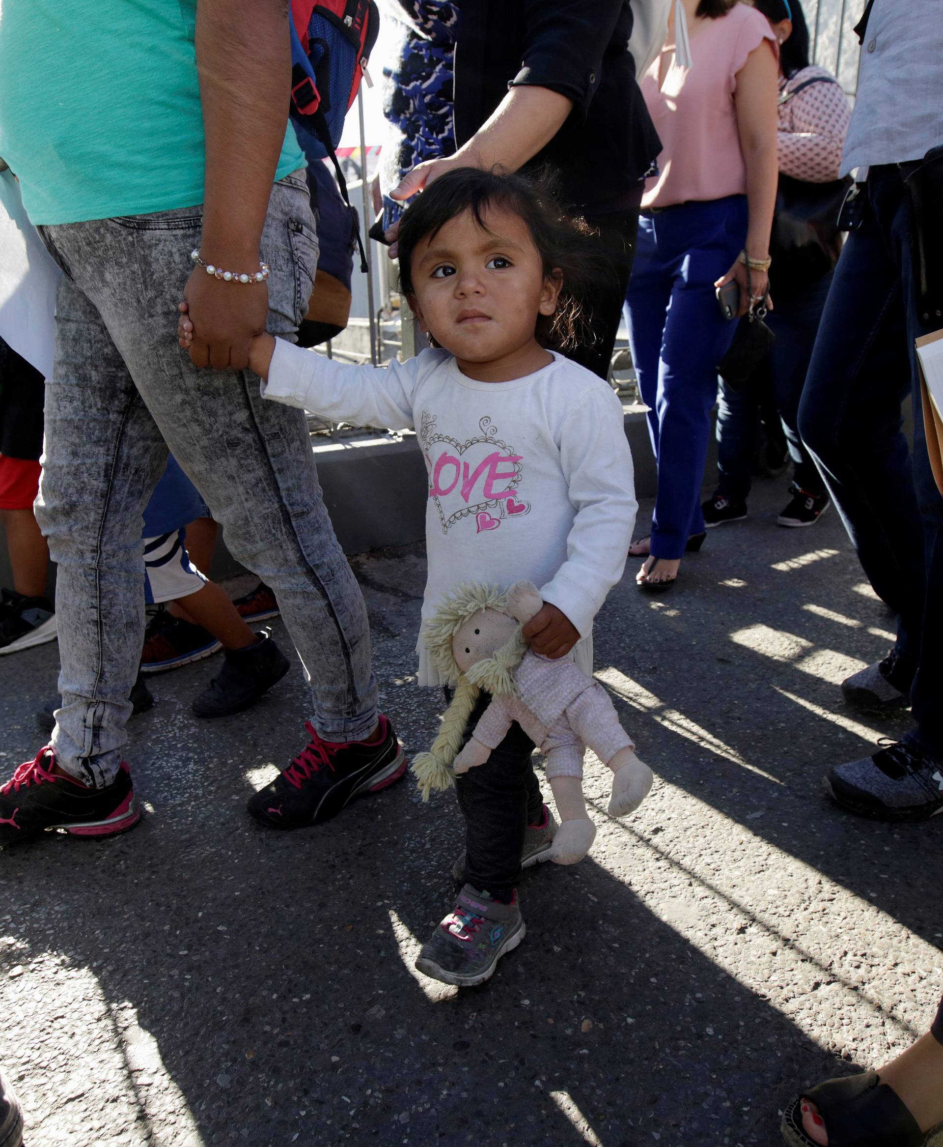Migrant families from Mexico, fleeing from violence, enter the United States to apply for asylum at Paso del Norte international border crossing bridge in Ciudad Juarez