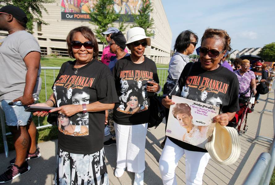 June Burnette holds an album by singer Aretha Franklin as she waits in line for Franklin's viewing at the Charles H. Wright African American Museum in Detroit