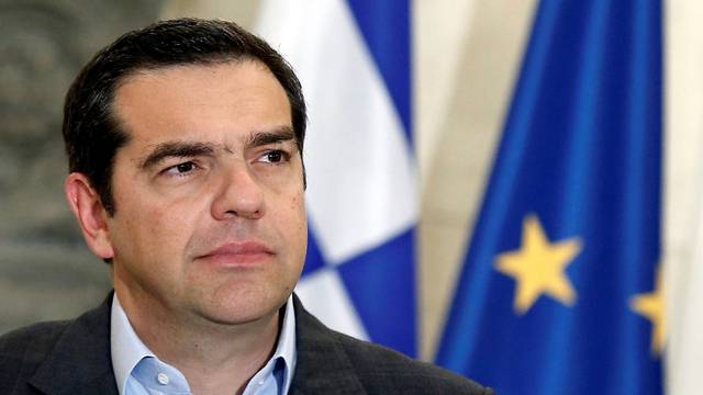 Greek Prime Minister Alexis Tsipras attends joint statements with his Danish counterpart Lars Loekke Rasmussen after their meeting at the Maximos Mansion in Athens