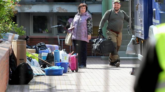 People leave the building of Russian embassy school in Warsaw