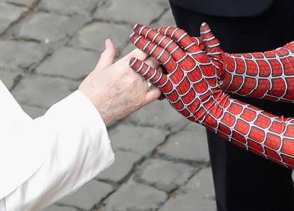 Pope Francis greets a person dressed as Spiderman, at the Vatican