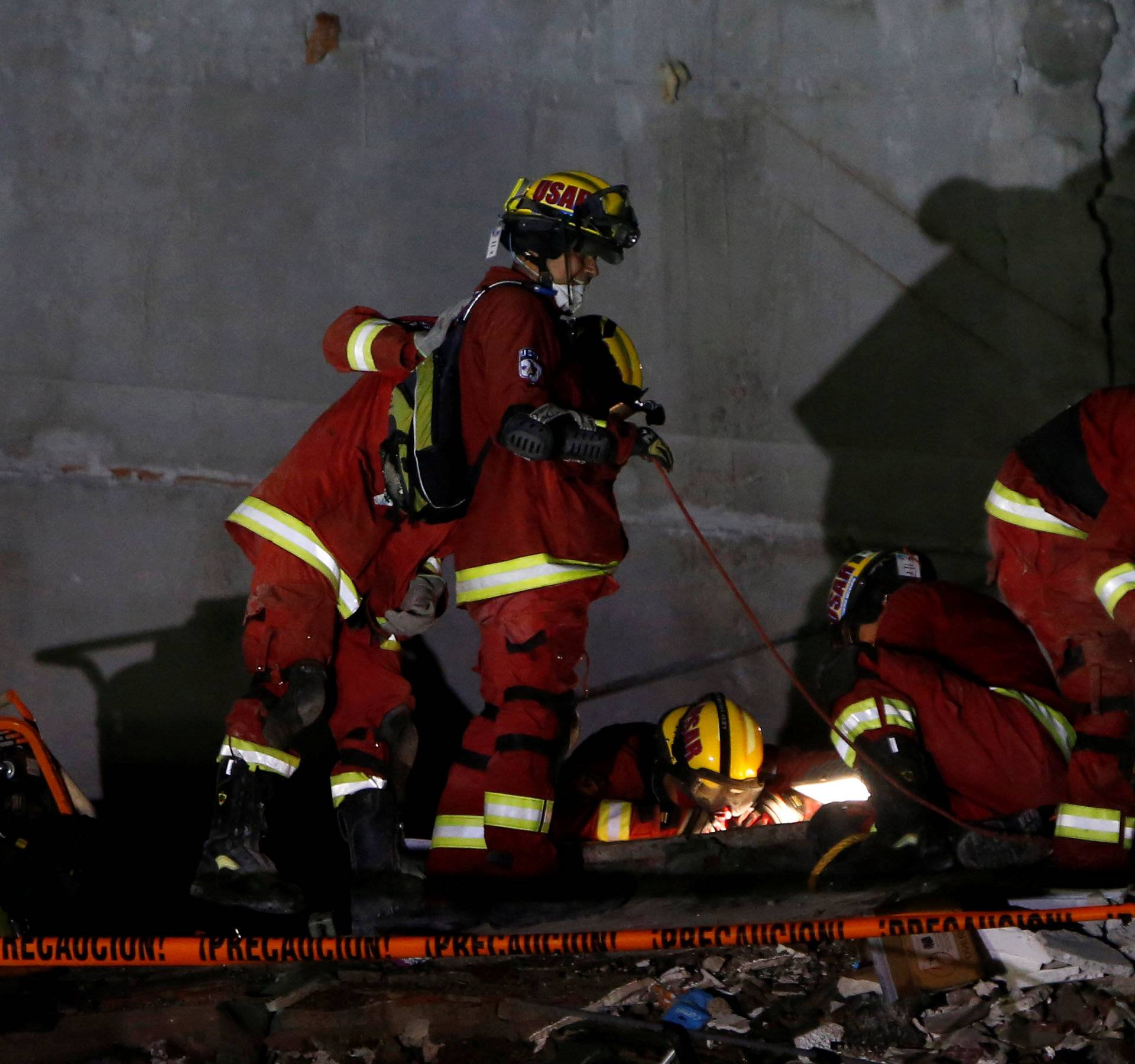 USAR rescue team searches for survivors in the rubble of a collapsed building after an earthquake in Mexico City