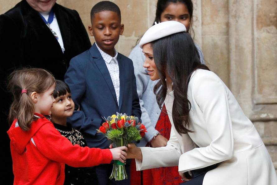 Britain's Prince Harry's fiancee Meghan Markle receives a bouquet of flowers after attending the Commonwealth Service at Westminster Abbey in London