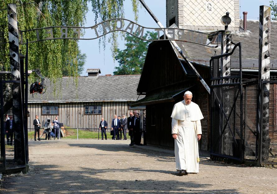 Pope Francis walks through Auschwitz's notorious gate during his visit to the former Nazi death camp