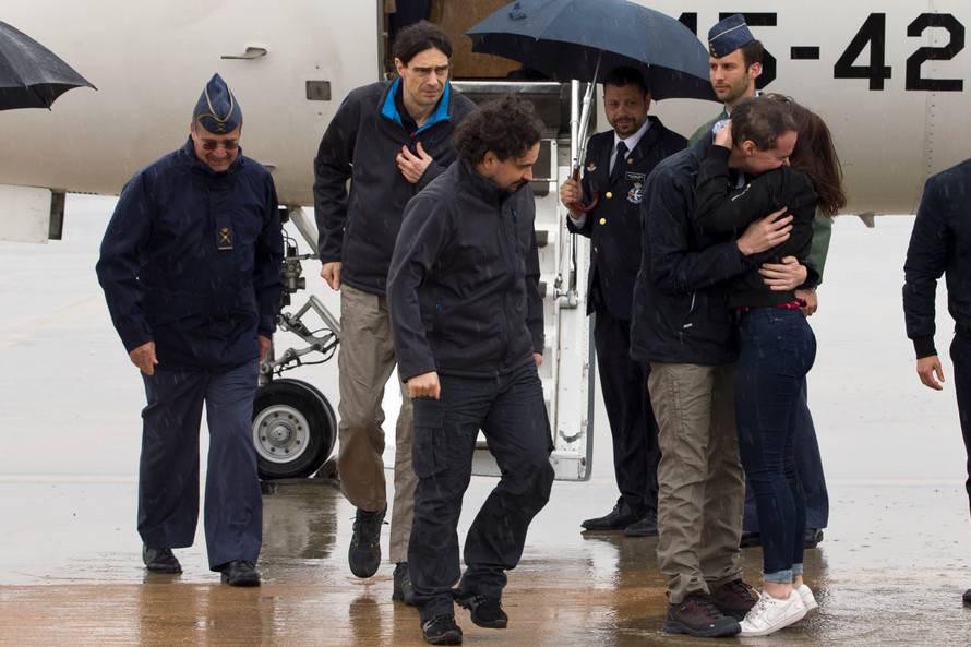 Pampliega, Lopez and Sastre, three Spanish freelance journalists who went missing in Syria last year and were believed to have been kidnapped, arrive at Torrejon's military airport, Spain