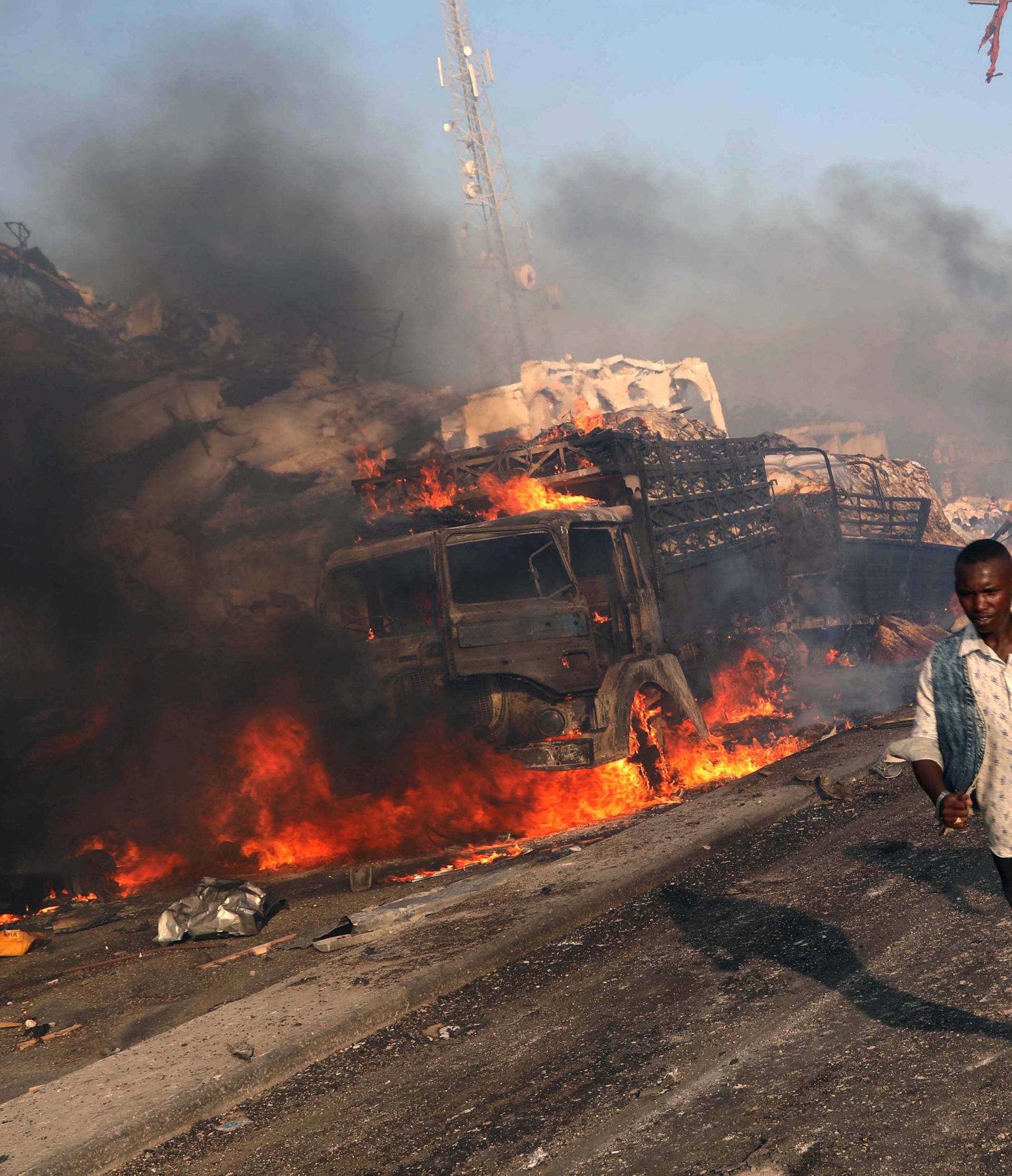 Civilians evacuate from the scene of explosion in Mogadishu