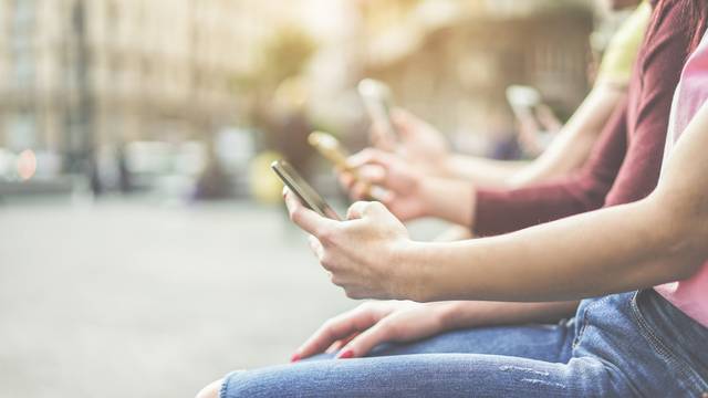 Group,Of,Teenagers,Friends,Watching,Mobile,Phones,In,City,-