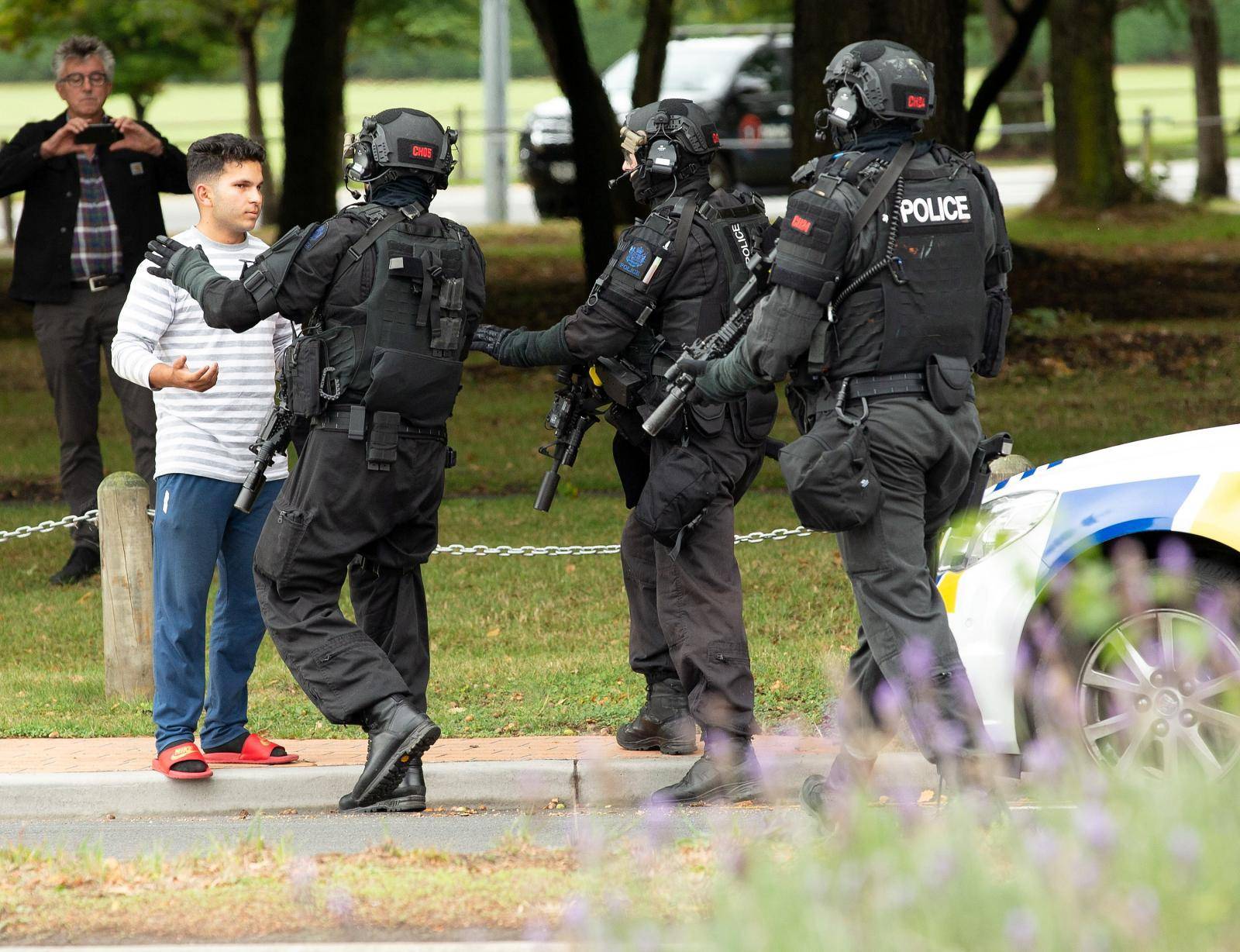 AOS (Armed Offenders Squad) push back members of the public following a shooting at the Masjid Al Noor mosque in Christchurch