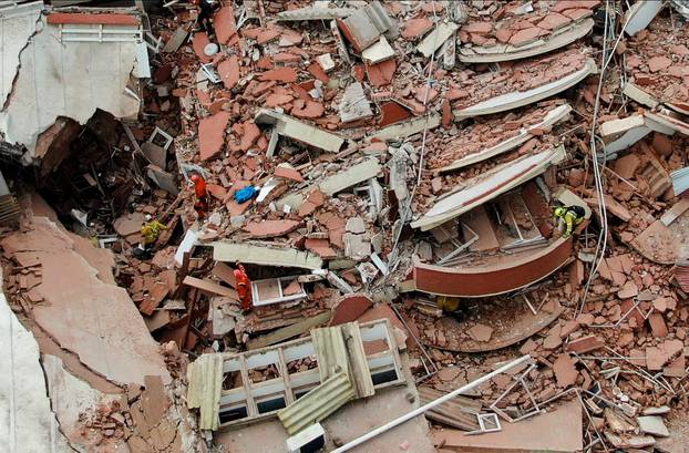 Firefighters search for trapped people after a hotel collapses in Villa Gesell