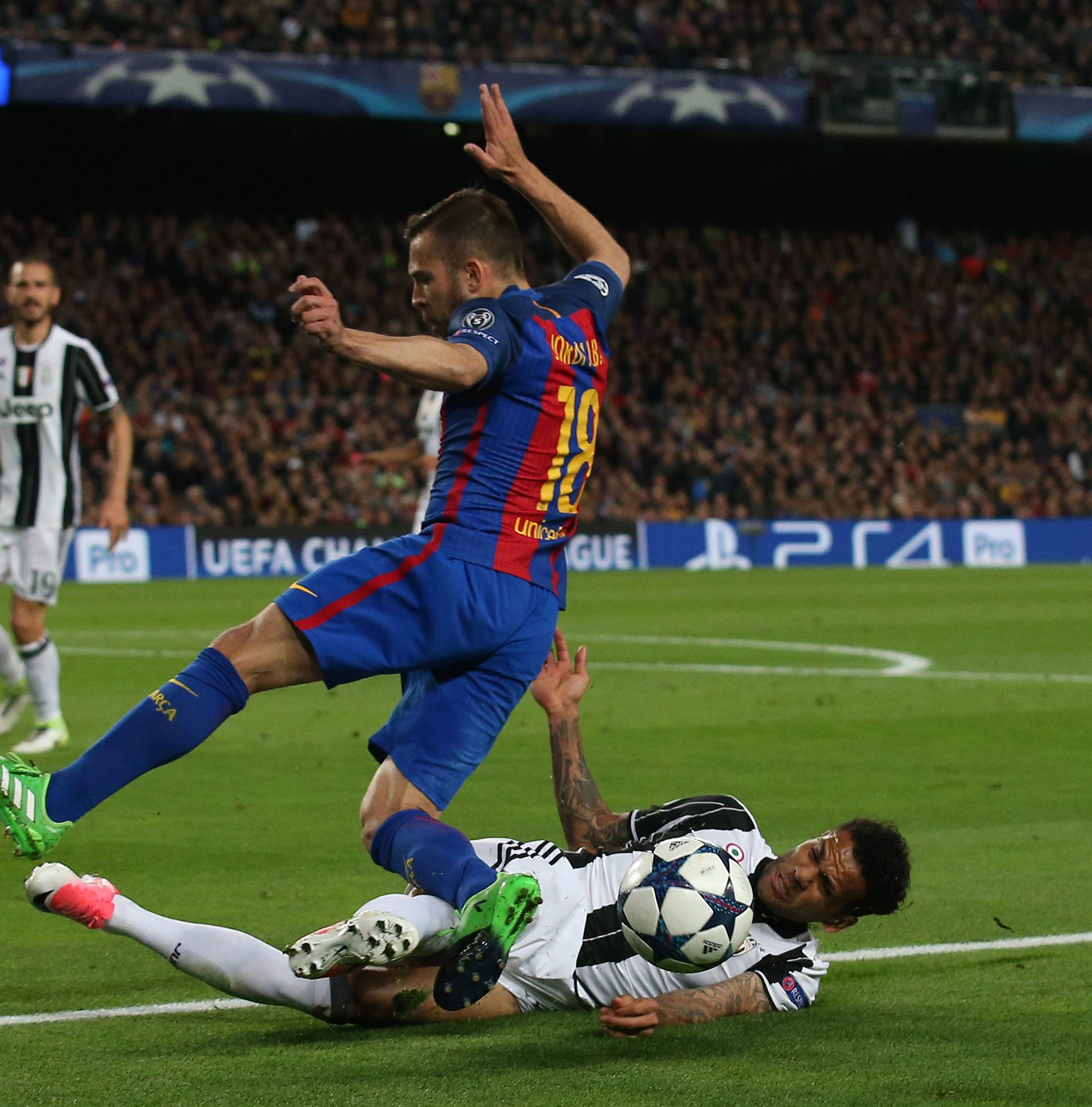 Barcelona's Jordi Alba in action with Juventus' Dani Alves