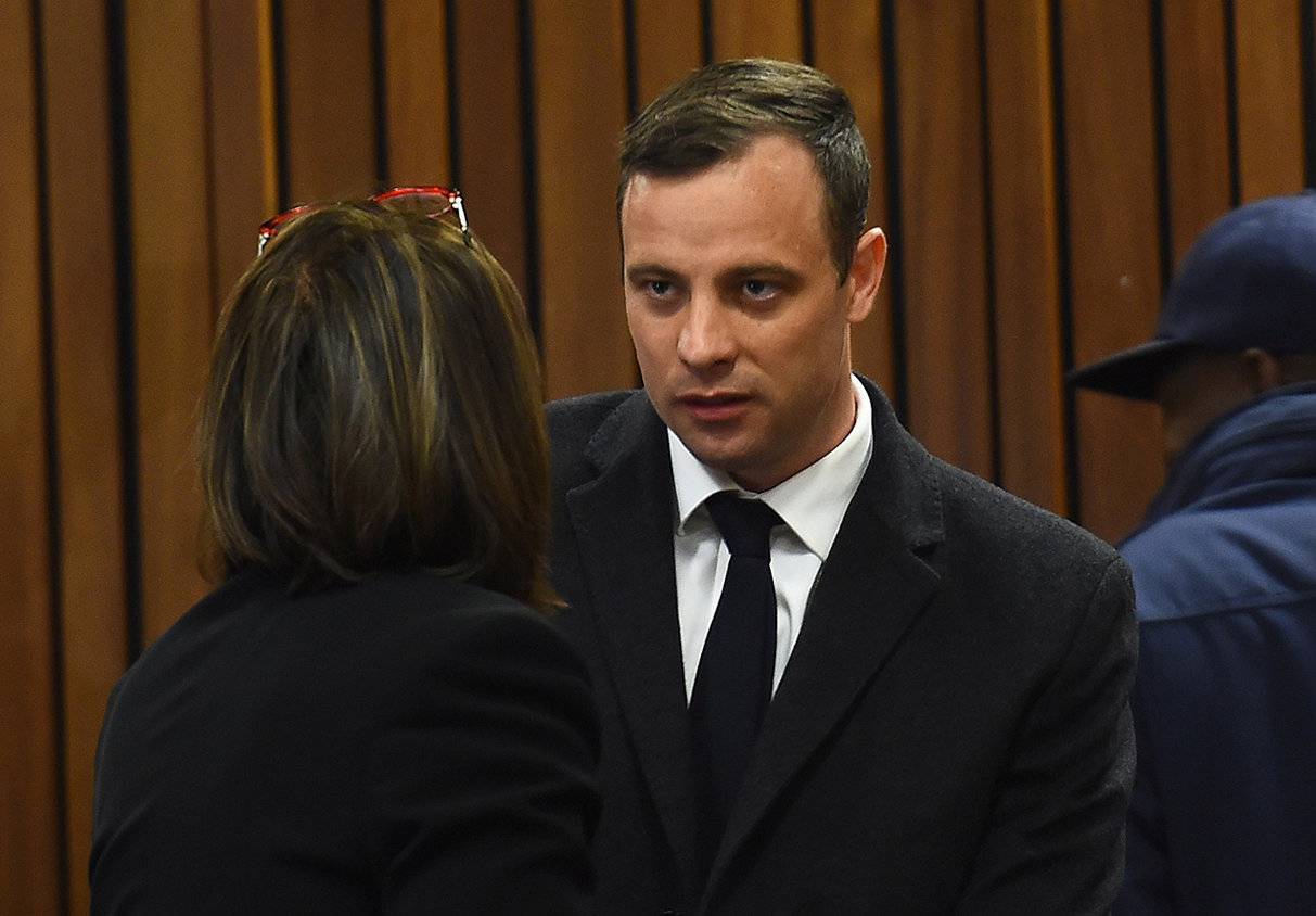 Olympic and Paralympic track star Oscar Pistorius speaks with his lawyer Barry Roux ahead of his sentence hearing at the North Gauteng High Court in Pretoria