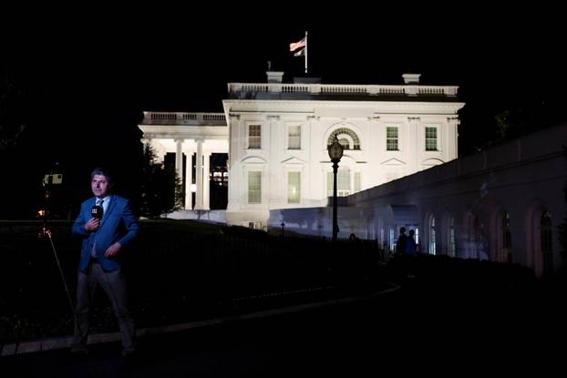 Member of the media report from the White House in Washington