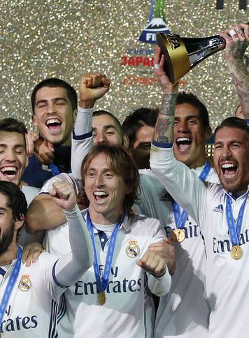 Real Madrid's Sergio Ramos and team mates celebrate winning the FIFA Club World Cup Final with the trophy