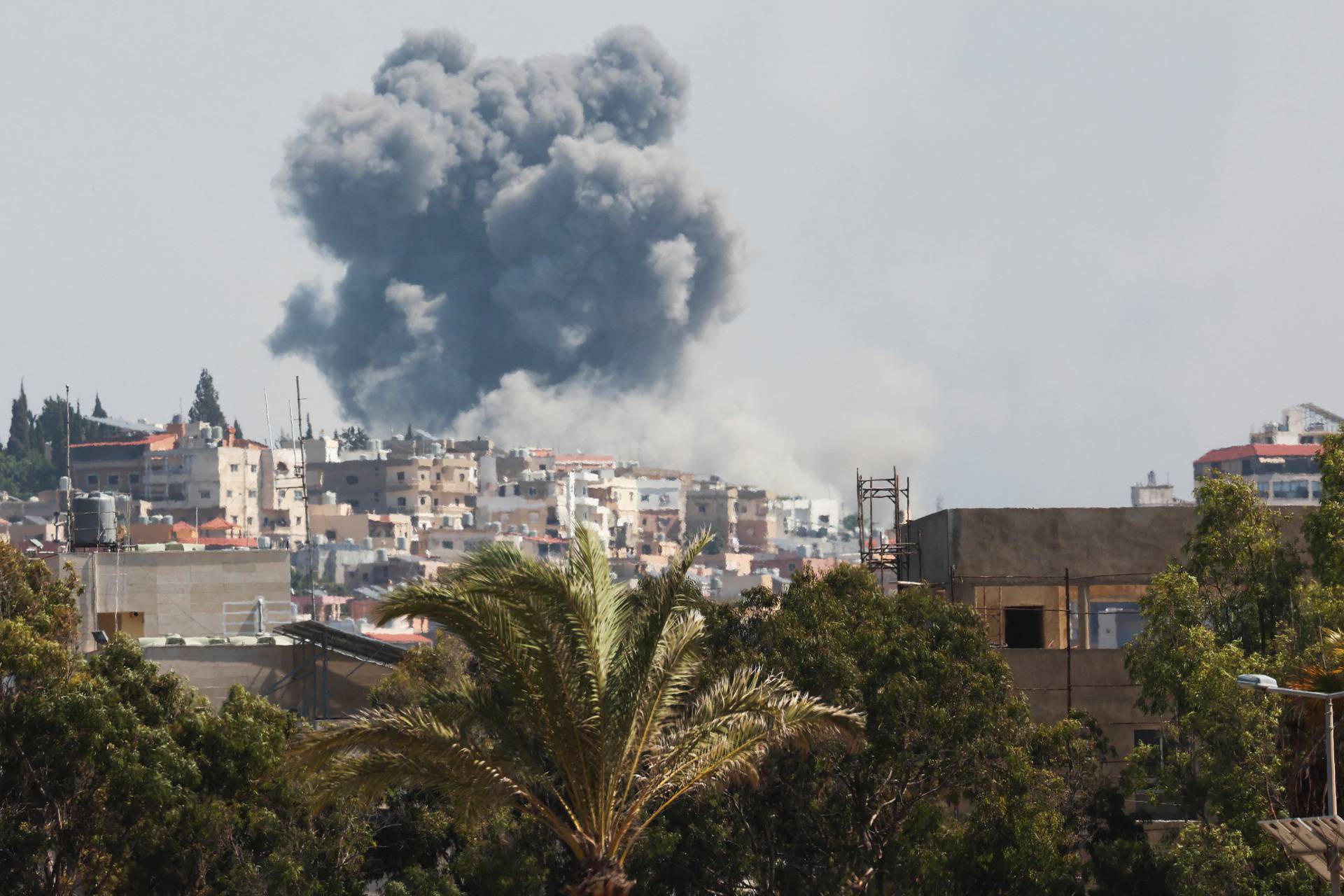 Smoke billows over southern Lebanon following Israeli strikes, as seen from Tyre, southern Lebanon