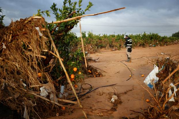 Members of the military search for bodies of people missing after heavy rains, in Quart de Poblet