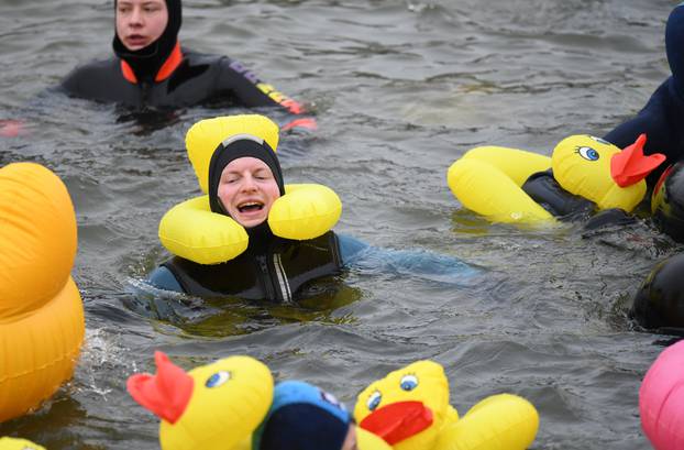 Swimmers wearing costumes bathe in the 3 degrees Celsius water of the river Danube during their annual 4 km swim, in Neuburg an der Donau