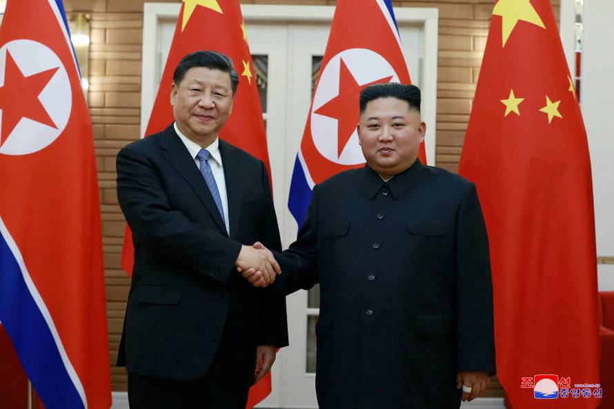 FILE PHOTO: North Korean leader Kim Jong Un shakes hands with China's President Xi Jinping during Xi's visit in Pyongyang, North Korea in this undated photo released on June 21, 2019 by North Korea's Korean Central News Agency (KCNA)