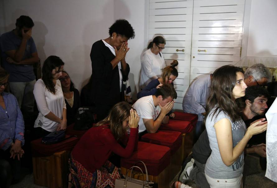 Relatives of Brazilian journalist Guilherme Marques mourn during a mass in Rio de Janeiro